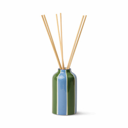 The Misted Lime - A Dopo 4 oz Diffuser features a green and blue ceramic vase with several long, thin reeds, perfect for diffusing fragrance, displayed against a plain white background.