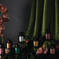 The Apothecary Noir collection on a table with green cloth.