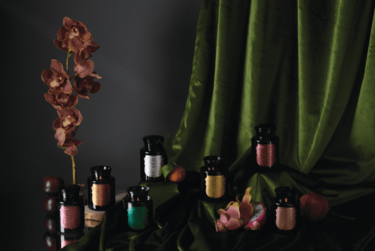 The Apothecary Noir collection on a table with green cloth.