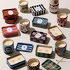 A group of candles in small containers.
