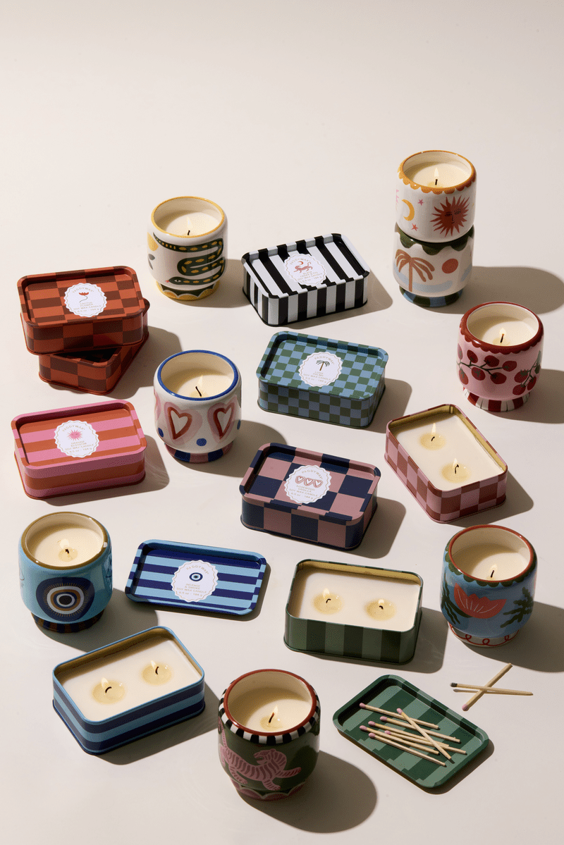 Collection of various candles of the A Dopo collection in different containers on a light background