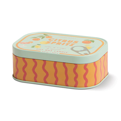 A rectangular tin with wavy orange and pink stripes on the sides and a light green lid, featuring citrus fruit illustrations and labeled "Citrus Spritz - Bistro Tin 4.5 oz Candle"; contains soy wax.