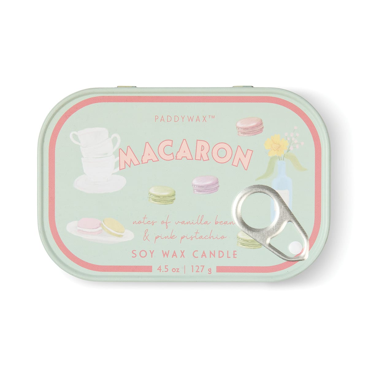 The Macaron - Bistro 4.5 oz Tin Candle comes in a pastel green tin adorned with playful illustrations of macarons, teacups, and a flower vase. French-inspired, it enchants with a Macaron fragrance combining vanilla bean and pink pistachio. This charming candle is finished with a convenient pull-tab lid.