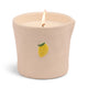 The Bistro Candle - Meyer Lemon features a lit white candle in a cream ceramic holder, adorned with a small painted Meyer Lemon, from the Bistro Collection.