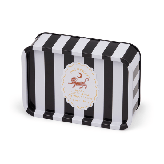 The Black Cedar & Fig - A Dopo 6.5 oz Tin Candle features bold black and white stripes and a round center label—this Mediterranean-inspired soy wax candle is perfect for travel or any adventure.