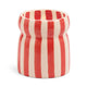 The Cabana Red Candle - Hibiscus Bay features a cylindrical ceramic holder with vertical red and white stripes and an outward-curving rim, perfect for displaying hand painted candles.