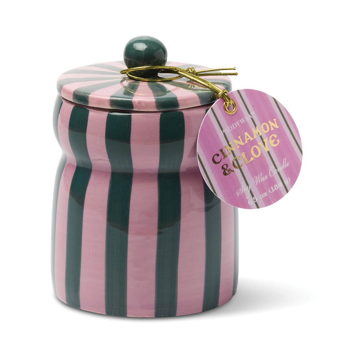A pink and dark green striped ceramic jar with a matching lid and round handle, featuring a gold string holding a round tag labeled “Cinnamon & Clove - Cabana 6.5 oz Candle.”.
