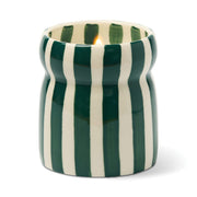 The Isla Fresca - Cabana 6.5 oz Candle is a ceramic candle holder with vertical green and white stripes, holding a lit candle.