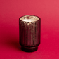 Front view of A lit 12 oz. tall mercury glass vessel on red background