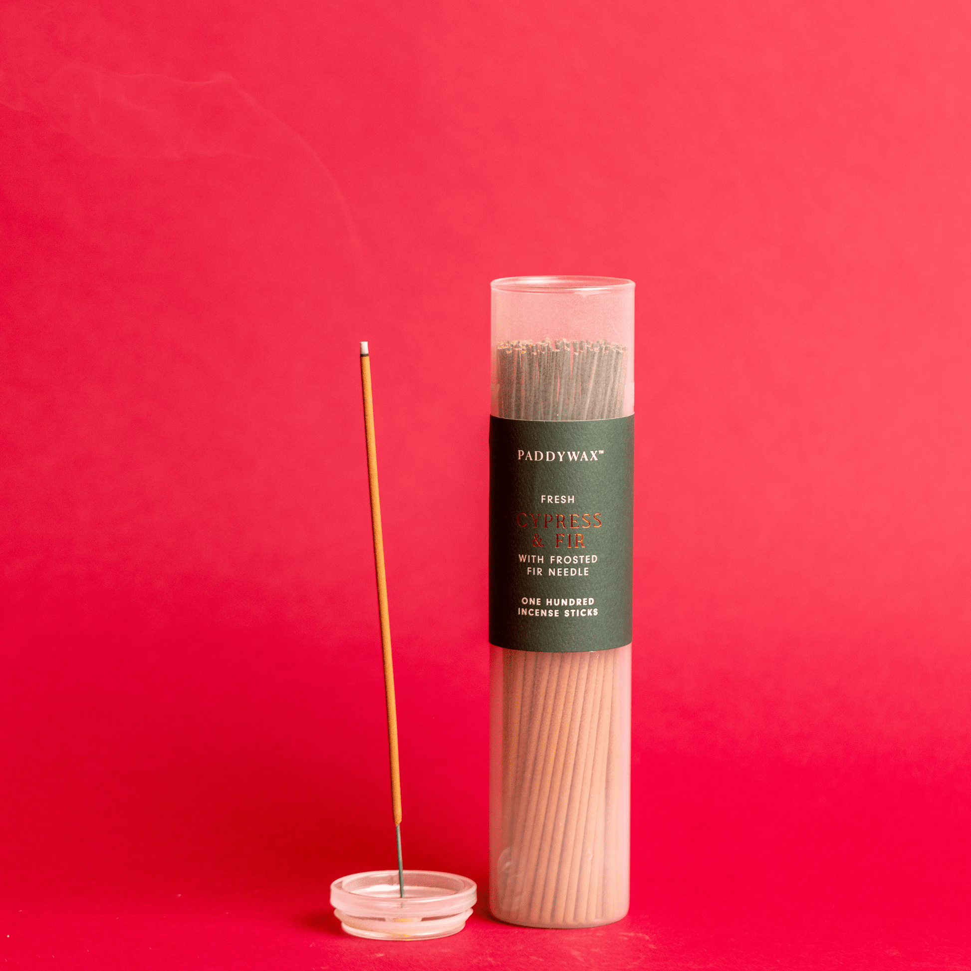 Cypress + Fir - Incense Sticks on red background; one stick lit