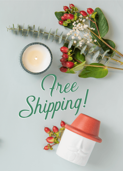 A candle, sprigs of berries and leaves, and a decorative container are arranged around the text Free Shipping! on a light surface.
