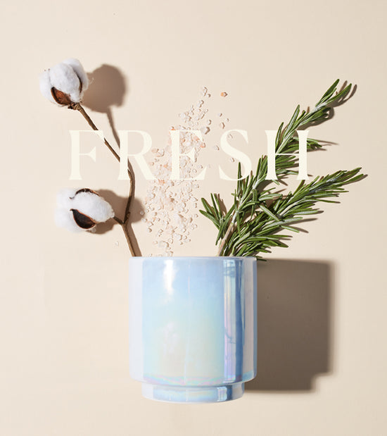 Candle with rosemary and cotton sprigs