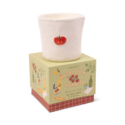 The Heirloom Tomato - Bistro 8 oz Candle features a white ceramic holder with a red tomato design, sitting on a decorative box with kitchen-themed illustrations from the Paddywax Bistro collection.