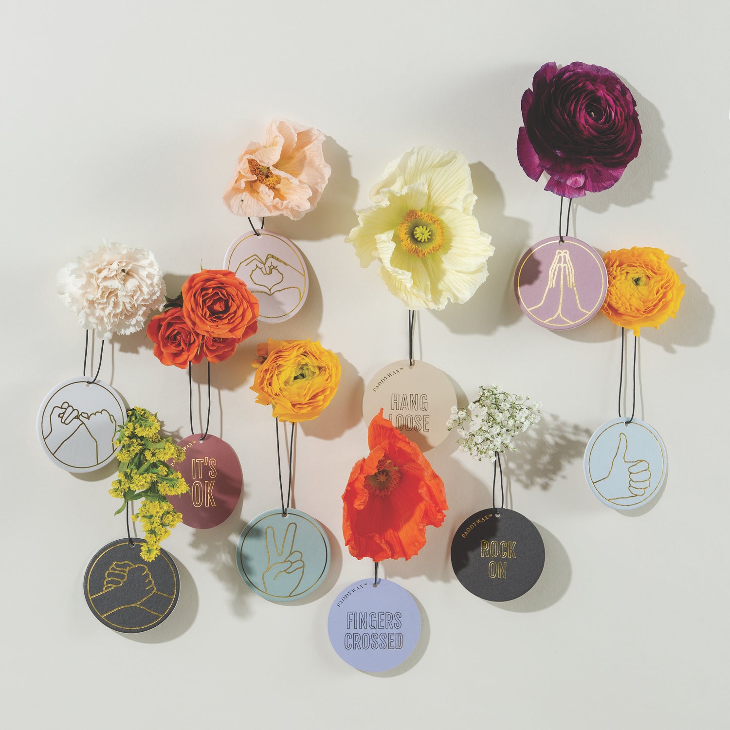 Impressions car fragrances hanging wall with florals around them