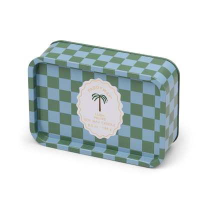 A rectangular tin candle with a blue and green checkerboard pattern and a central label reading “Lush Palms - A Dopo 6.5 oz Tin Candle”—ideal for anyone who loves Mediterranean-inspired candles.