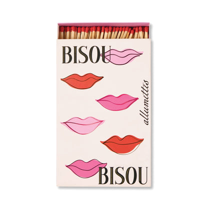 A hand-painted box of Bisou Bisou - Large Rectangle Boxed Matches features pink and red lips with BISOU and allumettes—an adorable Valentine’s gift. The open box shows off the colorful match tips.