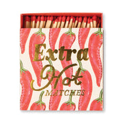 An open Extra Hot - Square Boxed Matches with red-tipped matches inside. The box shows chili pepper illustrations and gold text—an eye-catching host gift.