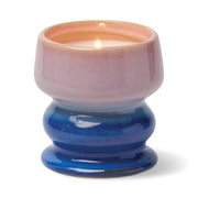 The Teakwood & Jasmine - Melt 8.5 oz Candle features a glossy ceramic holder with a pink upper half and blue lower half, photographed against a white background. This repurposable vessel brings inviting fragrance and stylish decor to any space.