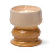 The Smoked Pistachio - Melt 8.5 oz Candle features an irresistible gourmand fragrance and comes in a glossy, two-tone ceramic holder with a wide base and a beige-to-tan gradient finish, filling your room with the warm scent of smoked pistachio when lit.