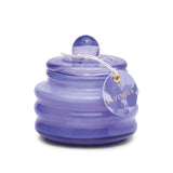 The Lavender - Beam 3 oz Candle features a round, ribbed lavender glass jar with a lid and a LAVENDER tag tied with string—ideal for adding a cozy touch to any space.
