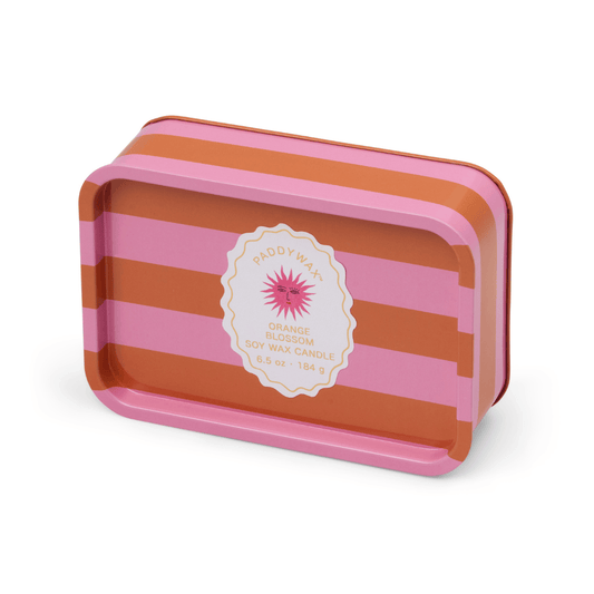 A rectangular tin candle with orange and pink stripes, labeled Orange Blossom - A Dopo 6.5 oz Tin Candle, featuring a floral design—ideal as a Mediterranean candle or reused as a trinket dish.