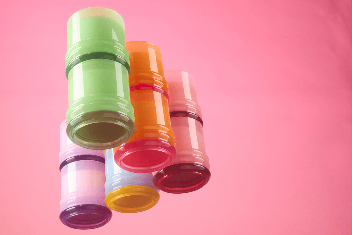 Colorful stackable candles on a pink background
