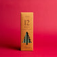 Cypress + Fir Taper 12 Days of Christmas Countdown Candle Set on red background