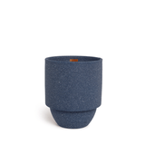 The Acadia - Parks 11 oz Candle features a blue, textured cylindrical design with a wider top and narrower base, evoking the cozy crackle of national park candles, displayed against a plain white background.