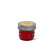 Pomegranate & Spruce - Relish 3 oz Candle in a small red textured glass jar with a metal lid and a label reading Pomegranate + Spruce.