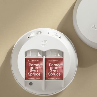 Paddywax Pomegranate and Spruce Pura fragrance refills in a Pura device