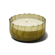 The Secret Garden - Ripple 12 oz Candle is shown lit, with three wicks burning in a round, greenish-brown vintage ribbed glass holder featuring scalloped edges, set against a plain white background.