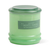 The Minty Verde - Stack 7 oz Candle features a mint-green glass jar with a matching lid. The white label displays the product name, and the reusable vessel makes it a sustainable choice even after the candle is burned.
