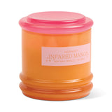 An orange glass vessel with a pink lid labeled "Infrared Mango - Stack 7 oz Candle"—ideal for reuse as storage after enjoying its fragrance.