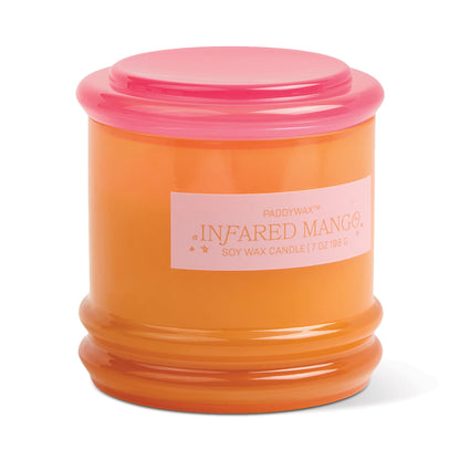 An orange glass vessel with a pink lid labeled "Infrared Mango - Stack 7 oz Candle"—ideal for reuse as storage after enjoying its fragrance.