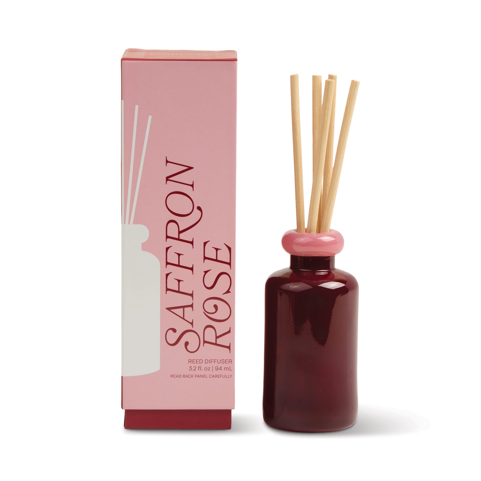 A pink and red box labeled "Saffron Rose - Stack 3.2 oz Diffuser" stands beside a matching dark red glass diffuser with a pink cap and natural wooden reeds, ideal for adding continuous fragrance to modern decor.