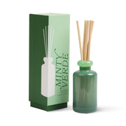 The Minty Verde - Stack 3.2 oz Diffuser, a green vessel with wooden reeds, stands next to its matching box labeled "Minty Verde" and illustrated with the bottle, delivering continuous freshness.