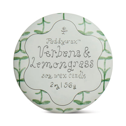 The Verbena & Lemongrass - Tulip 2 oz Tin Candle features a green leaf pattern inspired by an herb garden and whimsical handwritten-style text on its round tin lid.