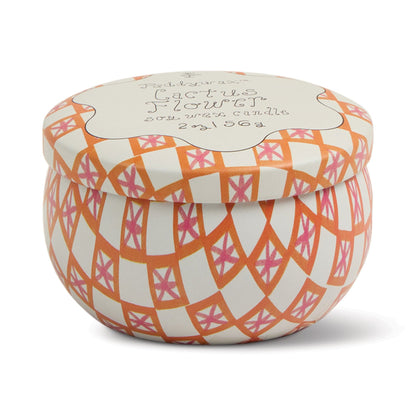The Cactus Flower - Tulip 2 oz Tin Candle comes in a round tin with a lid, featuring an orange, pink, and white geometric design and handwritten-style text, evoking the fresh scent of desert blooms.