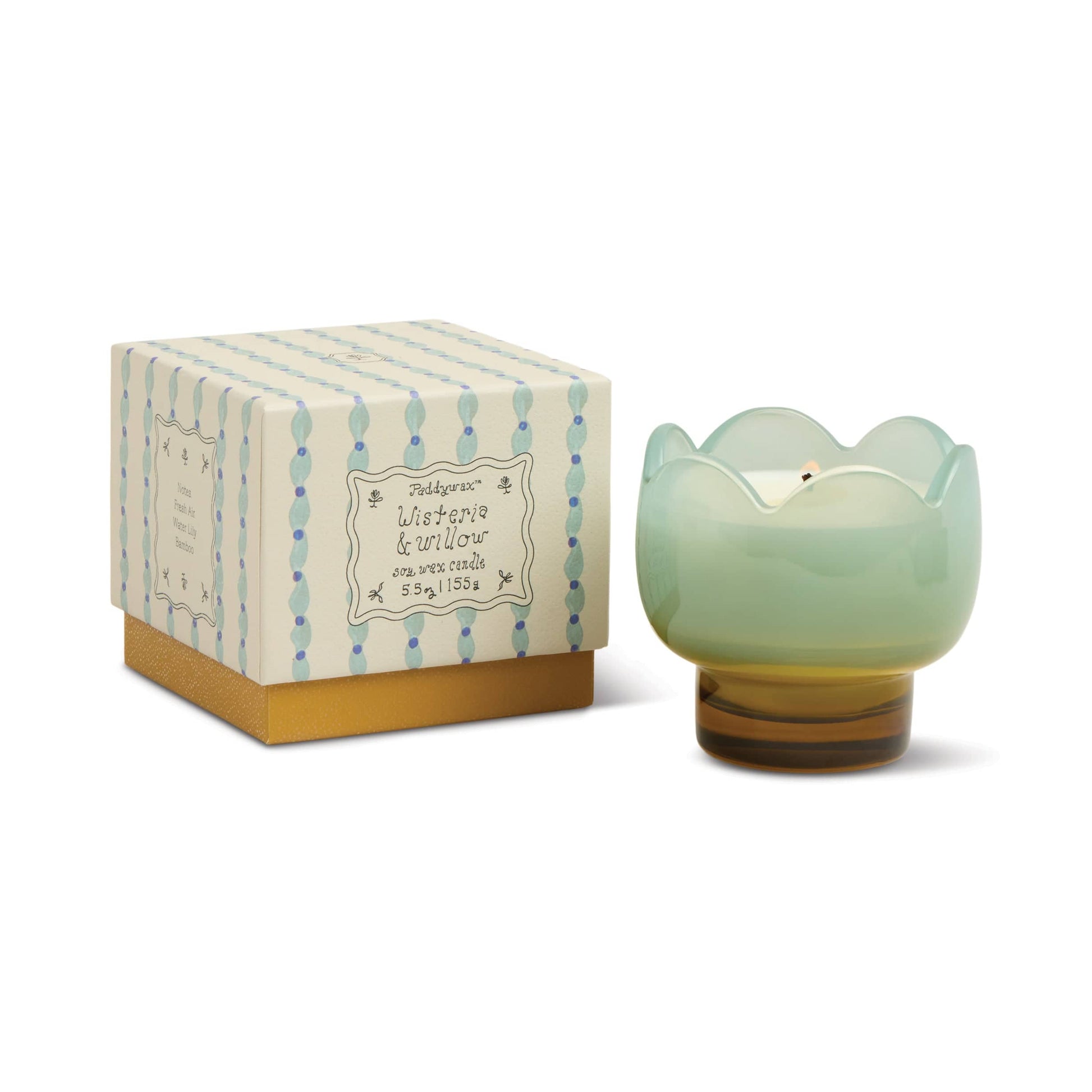 The Wisteria & Willow - Tulip 5.5 oz Candle features a decorative wisteria scent in a pale green, flower-shaped teal glass vessel and comes in a patterned box with pastel botanical designs, dots, and lines.