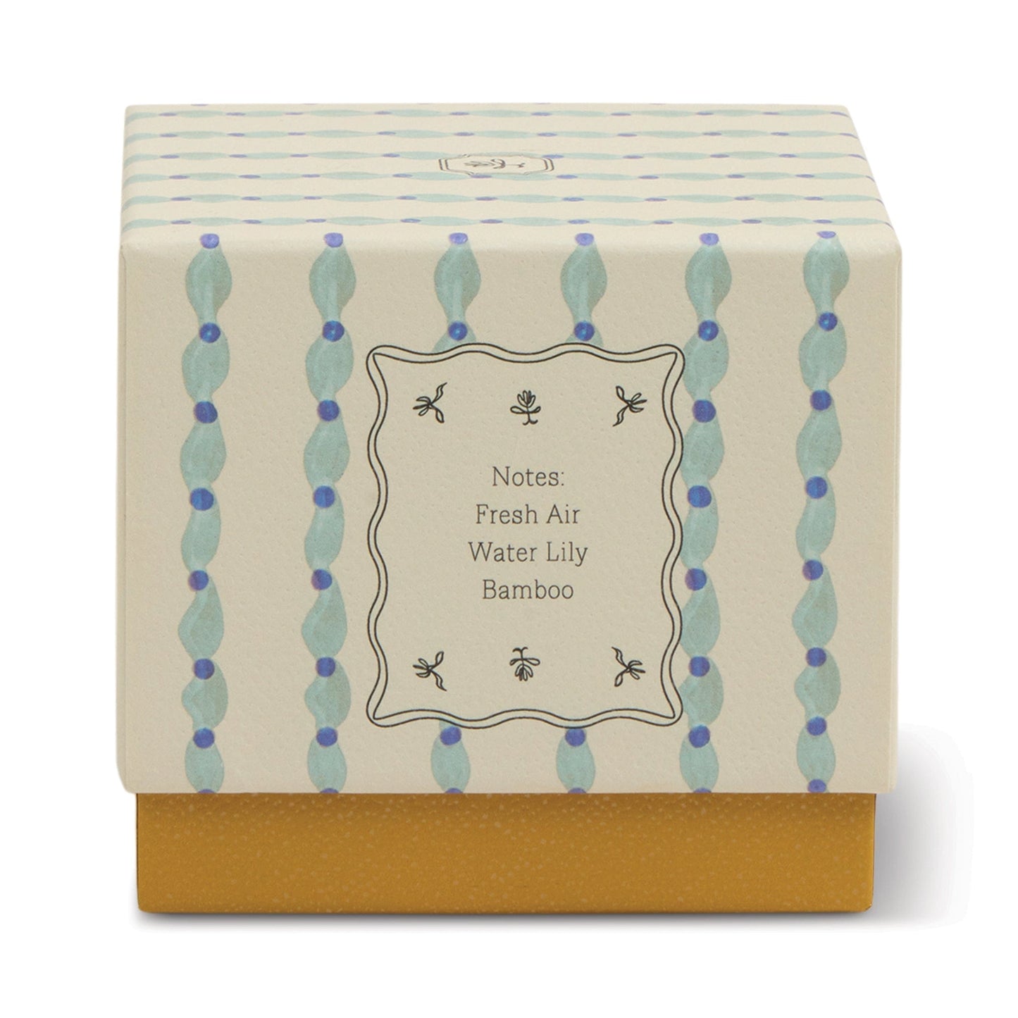 The Wisteria & Willow - Tulip 5.5 oz Candle comes in a decorative botanical box with a cream and blue patterned lid labeled Fresh Air, Water Lily, Bamboo. Its solid mustard yellow base is perfect for teal glass vessels or wisteria candles.