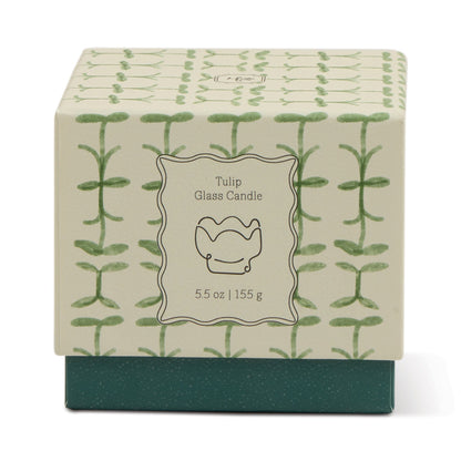 A decorative box labeled "Verbena & Lemongrass - Tulip 5.5 oz Candle" features a green plant pattern on cream, a dark green base, and a centered tulip illustration—perfect for your favorite lemongrass scent.