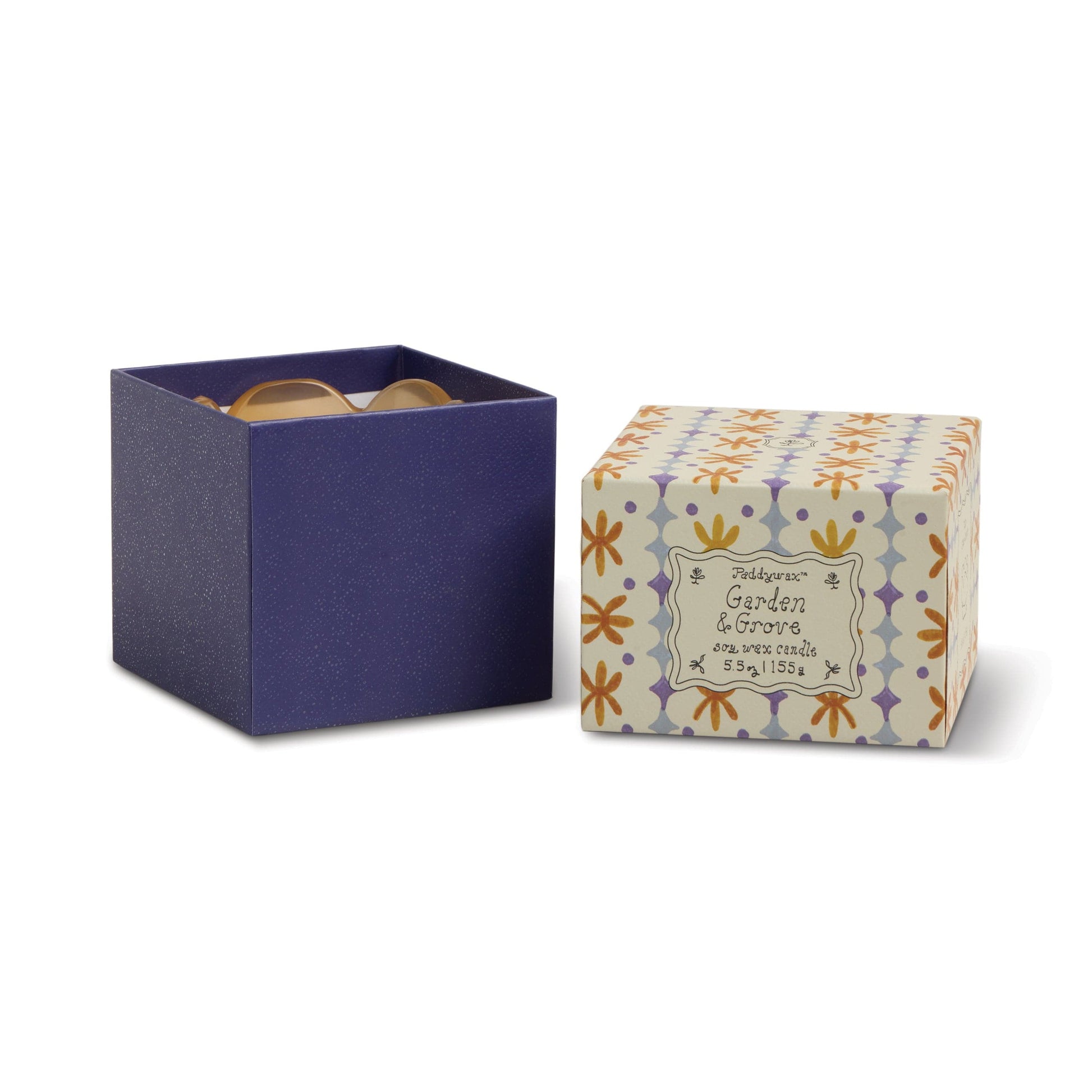 A Garden & Grove - Tulip 5.5 oz Candle with a yellow, orange, and purple floral pattern sits next to a dark blue glasses box. The candle’s design is ideal for garden-inspired home decor.