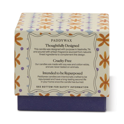 The Garden & Grove - Tulip 5.5 oz Candle comes in a decorative box with floral patterns and a label: Paddywax – Thoughtfully Designed, Cruelty-Free, Intended to be Repurposed. Ideal for garden-inspired home decor; includes product and safety info.