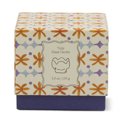 A decorative candle box labeled Garden & Grove - Tulip 5.5 oz Candle features a floral orange and purple pattern and a simple line drawing of a rustic vessel, perfect for garden-inspired home decor.