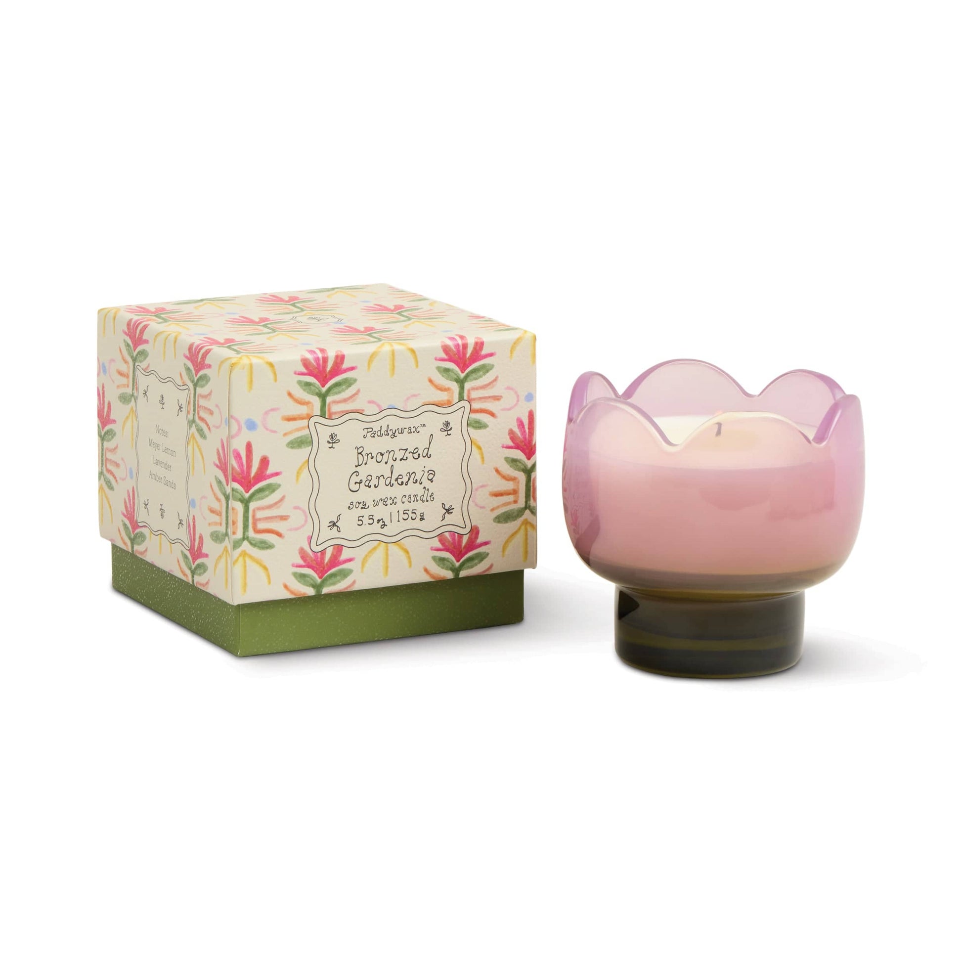 A pink, tulip-shaped vessel holds the Bronzed Gardenia - Tulip 5.5 oz Candle beside a decorative “Portoland Gardenia” box, creating a charming piece of floral home decor.