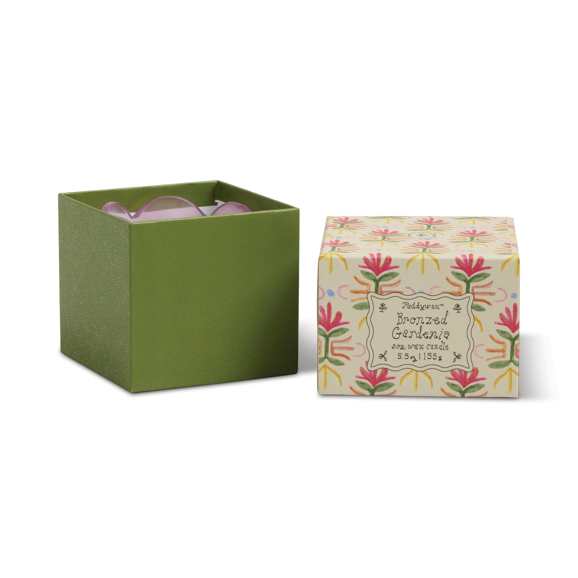 A green gift box with the lid removed reveals the Bronzed Gardenia - Tulip 5.5 oz Candle inside. The floral-patterned lid, marked "Bronzed Gardenia," sits beside the box, adding a decorative touch to the display.