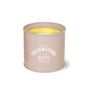 A beige 6 oz Paddywax Yellowstone - Parks Tin Candle labeled "Yellowstone Natl Park Sagebrush + Fir" with visible wax inside.