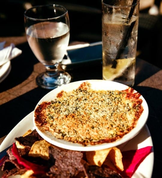 Chips with dip and drinks in the background
