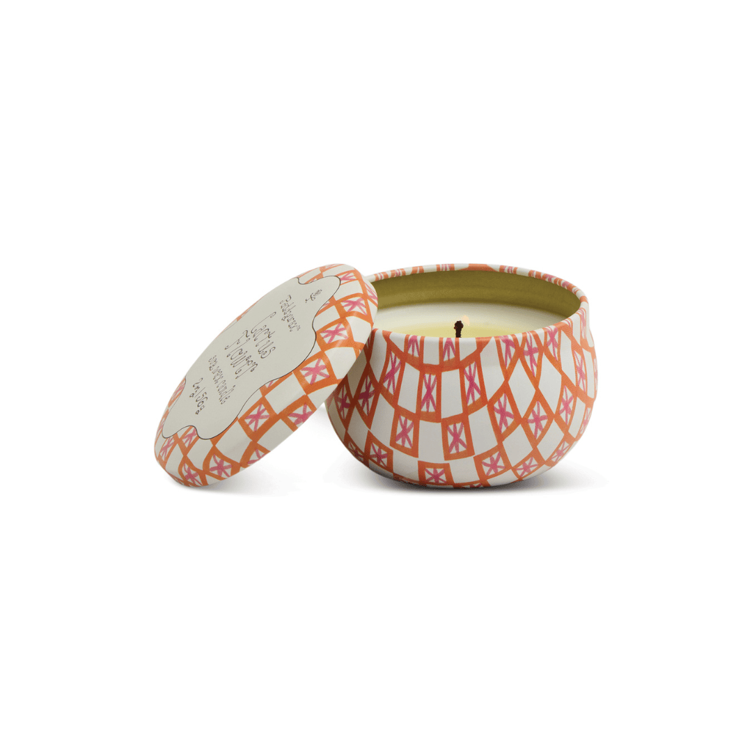 The Cactus Flower - Tulip 2 oz Tin Candle features an orange, pink, and white geometric design inspired by desert blooms. It comes in a round tin with a matching lid and has an unused, centered wick.