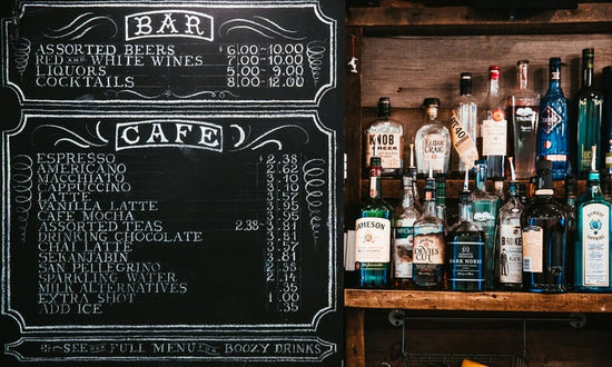 Cafe board menu with bottles next to it